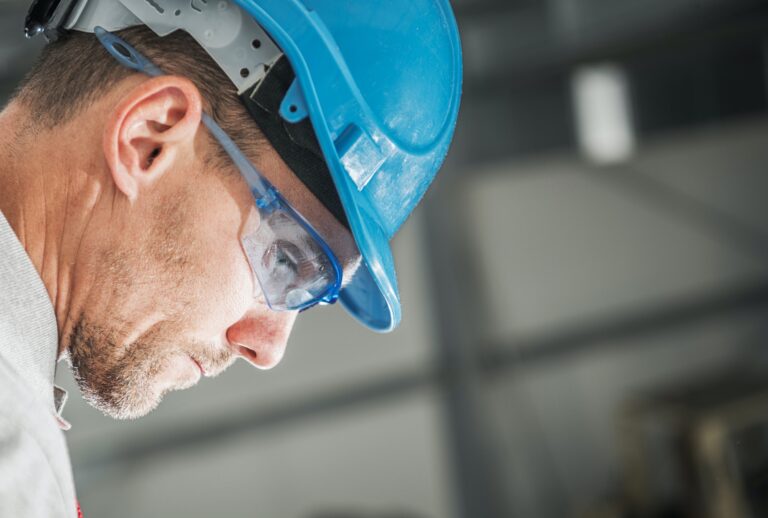 Construction Worker in Hard Hat and Eyes Safety Glasses